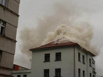Hasiči zasahují v ulici Kovářská v Praze 9, ze střechy budovy soukromé firmy vychází kouř.