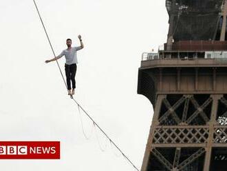 Get an Eiffel of this performer walking the line in Paris